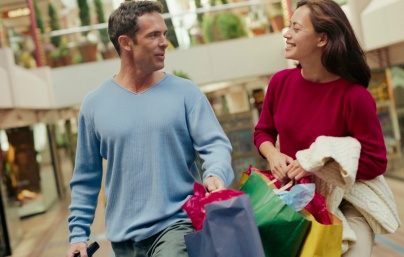 Couple Carrying Shopping Bags in Mall